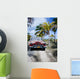Old car on a tropical beach Wall Mural