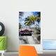 Old car on a tropical beach Wall Mural