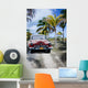 Old car on a tropical beach Wall Mural