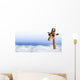 Funny giraffe with sunglasses coming out of the clouds Wall Mural