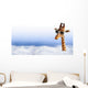 Funny giraffe with sunglasses coming out of the clouds Wall Mural