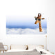 Funny giraffe with sunglasses coming out of the clouds Wall Mural