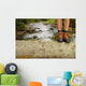 Hiking shoes legs on trunk on mountain trail. Wall Mural