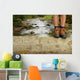 Hiking shoes legs on trunk on mountain trail. Wall Mural
