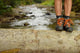 Hiking Shoes Legs On Trunk On Mountain Trail. Wall Decal