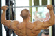 Back Of Bodybuilder Raising Barbell In Gym Hall Before Mirror Wall Decal
