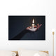 Holding a candle on a dark background. Wall Mural