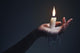 Holding A Candle On A Dark Background. Wall Decal