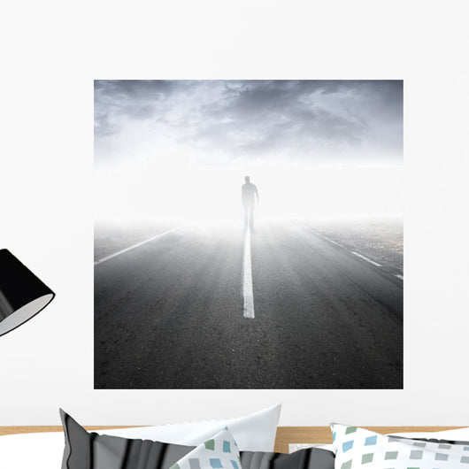 Asphalt highway perspective with walking man in the fog Wall Mural
