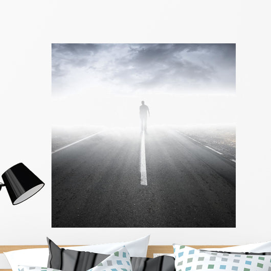 Asphalt highway perspective with walking man in the fog Wall Mural