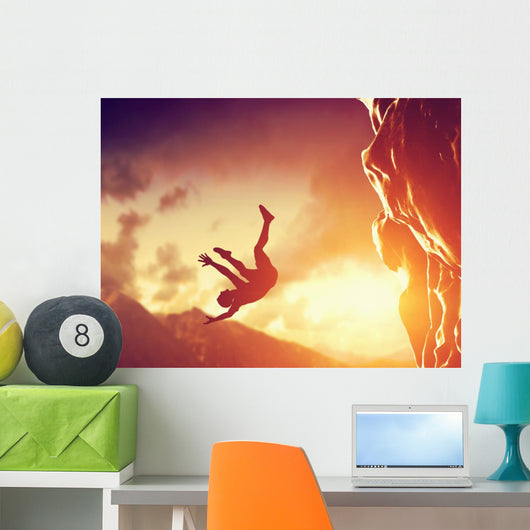 Hiker free falling from the mountain. Man in fatal situation Wall Mural