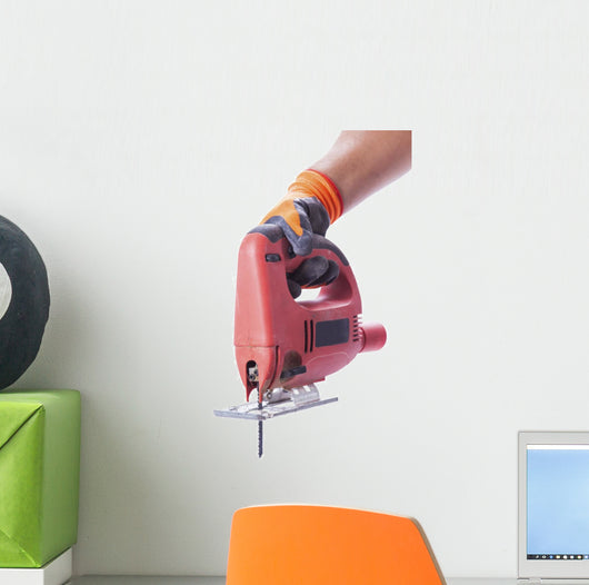 hand in a glove holds a working electric jig saw Wall Decal