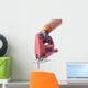 hand in a glove holds a working electric jig saw Wall Decal