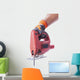 hand in a glove holds a working electric jig saw Wall Decal