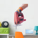 hand in a glove holds a working electric jig saw Wall Decal