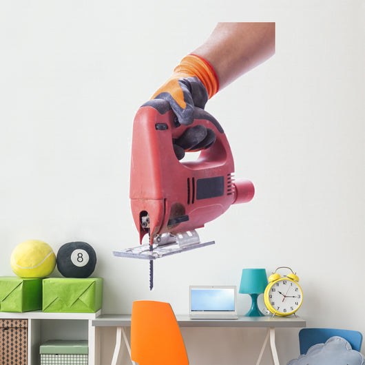 hand in a glove holds a working electric jig saw Wall Decal