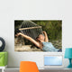 Happy woman relaxing on a hammock on holidays and raising arms Wall Mural
