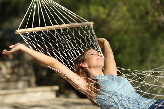 Happy Woman Relaxing On A Hammock On Holidays And Raising Arms Wall Decal