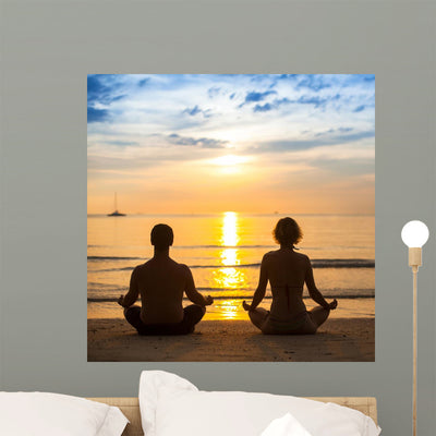 Young Couple Practicing Yoga On Sea Beach. Wall Decal shown on a wall