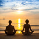 Young Couple Practicing Yoga On Sea Beach. Wall Decal