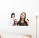 Teen girl pointing at dental barces with doctor in background. Wall Mural