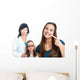 Teen girl pointing at dental barces with doctor in background. Wall Mural