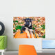 German Shepherd puppy sitting on pumpkins Wall Mural
