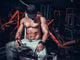 Muscle Shaped Man Tired Sitting Relaxed With Weights And Energy Wall Decal