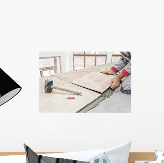 Handyman laying tile, trowel with mortar Wall Mural