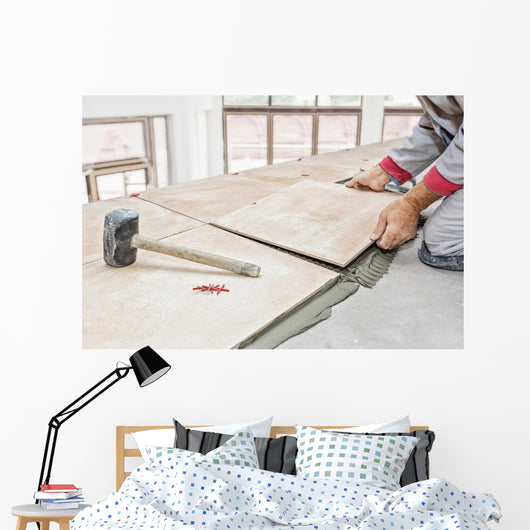 Handyman laying tile, trowel with mortar Wall Mural