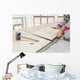 Handyman laying tile, trowel with mortar Wall Mural