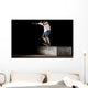 boy doing skateboard trick in skate park on night Wall Mural