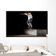 boy doing skateboard trick in skate park on night Wall Mural