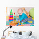 Cute little baby playing with colorful toys indoors Wall Mural