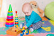 Cute Little Baby Playing With Colorful Toys Indoors Wall Decal
