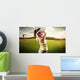 Woman golf player swinging with golf club Wall Mural