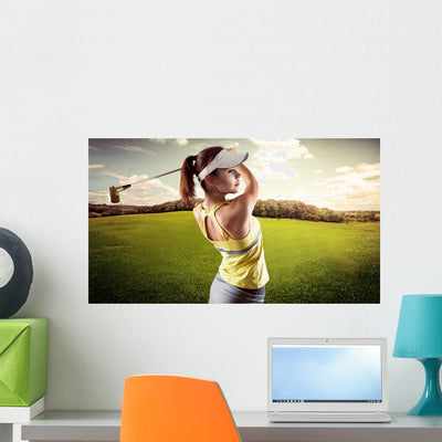 Woman Golf Player Swinging With Golf Club Wall Decal shown on a wall