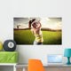 Woman golf player swinging with golf club Wall Mural