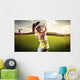 Woman golf player swinging with golf club Wall Mural