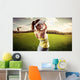 Woman golf player swinging with golf club Wall Mural