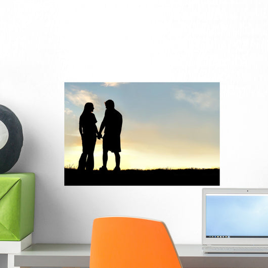 Silhouette of Happy Couple Holding Hands and Talking at Sunset Wall Mural