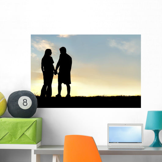 Silhouette of Happy Couple Holding Hands and Talking at Sunset Wall Mural