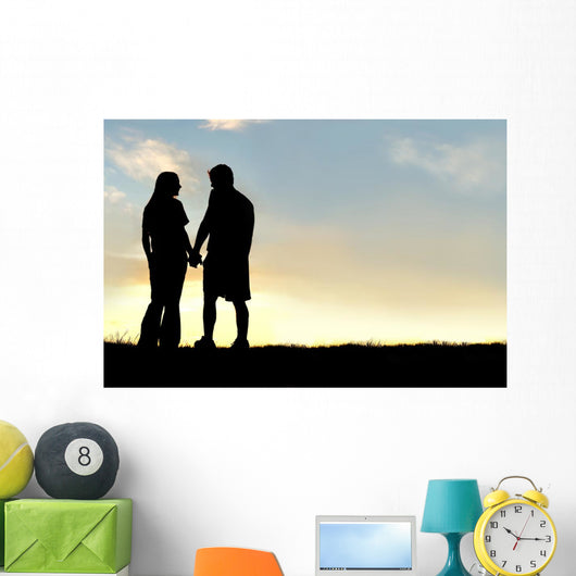 Silhouette of Happy Couple Holding Hands and Talking at Sunset Wall Mural