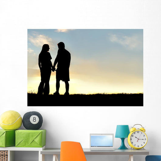 Silhouette of Happy Couple Holding Hands and Talking at Sunset Wall Mural