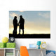 Silhouette of Happy Couple Holding Hands and Talking at Sunset Wall Mural