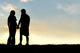 Silhouette Of Happy Couple Holding Hands And Talking At Sunset Wall Decal