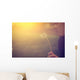 Woman blowing dandelion Wall Mural