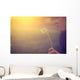 Woman blowing dandelion Wall Mural