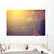 Woman blowing dandelion Wall Mural