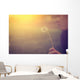 Woman blowing dandelion Wall Mural